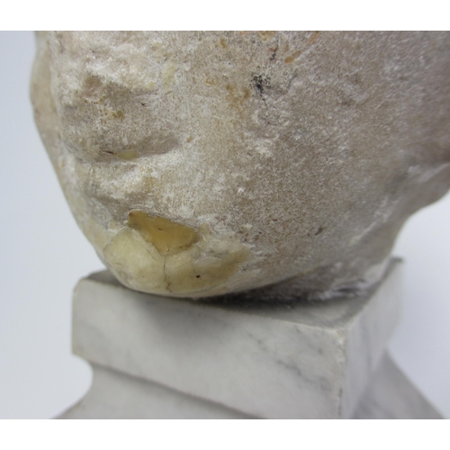 675 - A Roman marble head of a young boy