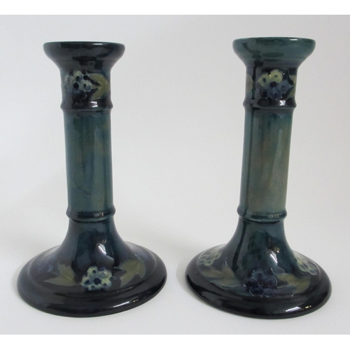 688 - A pair of Moorcroft Later Florian Forget-Me-Not pattern candlesticks