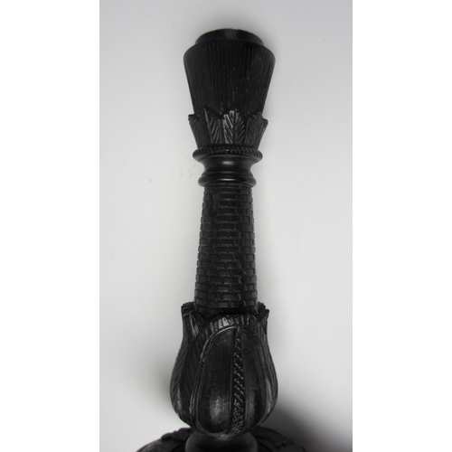 704 - A pair of Irish bog oak candlesticks