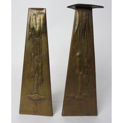 767 - A pair of Glasgow style embossed brass taper vases