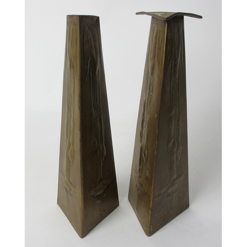 767 - A pair of Glasgow style embossed brass taper vases