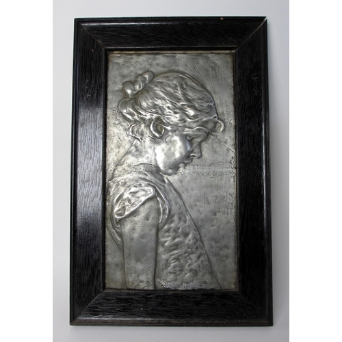 768 - An Arts and Crafts style cast metal plaque of a young girl