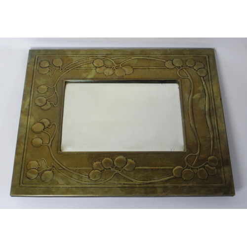 770 - A Glasgow Style embossed brass rectangular wall mirror