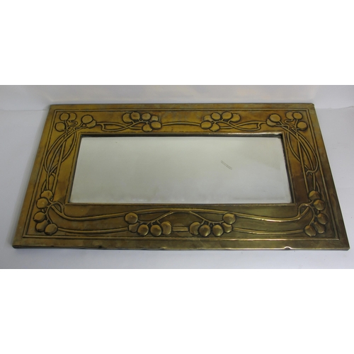 771 - A Glasgow style embossed brass tall rectangular wall mirror