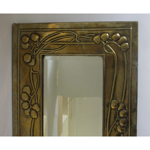 771 - A Glasgow style embossed brass tall rectangular wall mirror