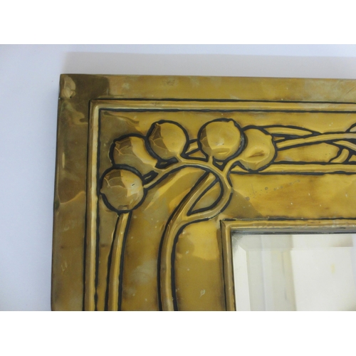 771 - A Glasgow style embossed brass tall rectangular wall mirror