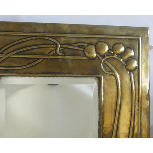 771 - A Glasgow style embossed brass tall rectangular wall mirror