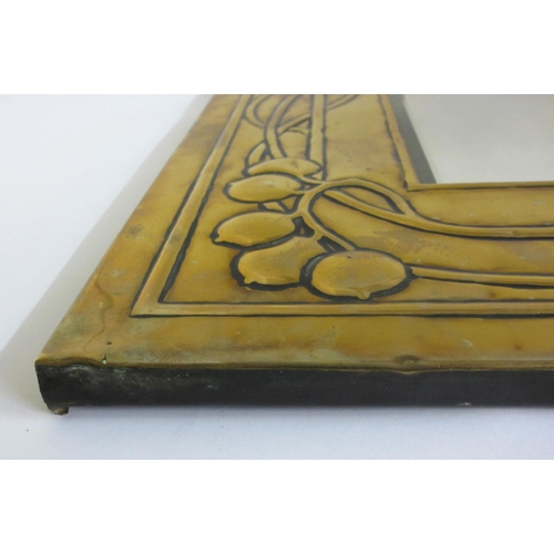 771 - A Glasgow style embossed brass tall rectangular wall mirror