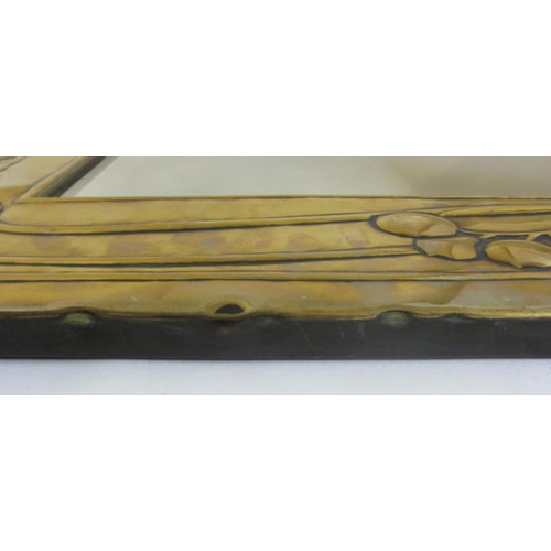 771 - A Glasgow style embossed brass tall rectangular wall mirror