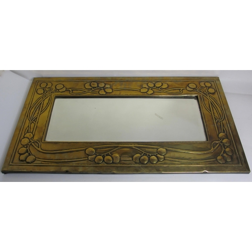 771 - A Glasgow style embossed brass tall rectangular wall mirror