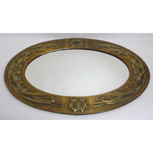 772 - A Glasgow style embossed brass oval wall mirror