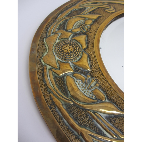 772 - A Glasgow style embossed brass oval wall mirror