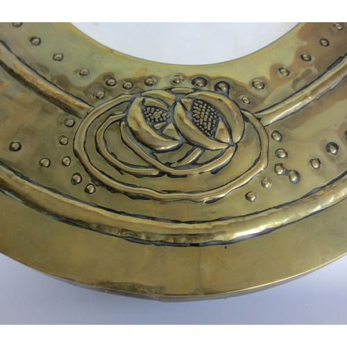 773 - A Glasgow style embossed brass oval wall mirror