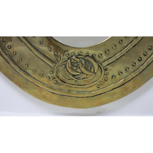 773 - A Glasgow style embossed brass oval wall mirror