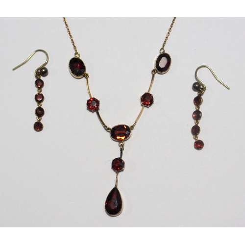 79 - A Victorian gold garnet pendant necklace and earrings