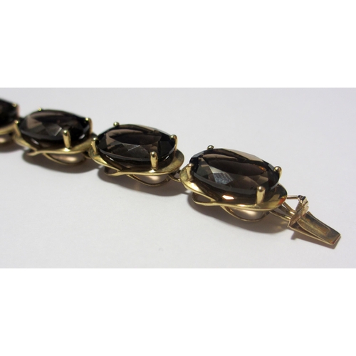 84 - A gold smoky quartz bracelet