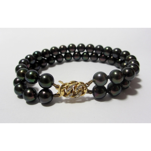 94 - A demi parure of black cultured pearl and diamond jewellery