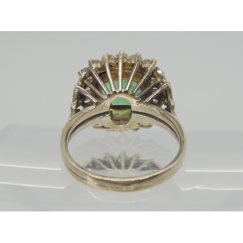 2706 - AN EMERALD AND DIAMOND RINGset throughout in yellow and white metal with diamond set fleur de lys sh... 