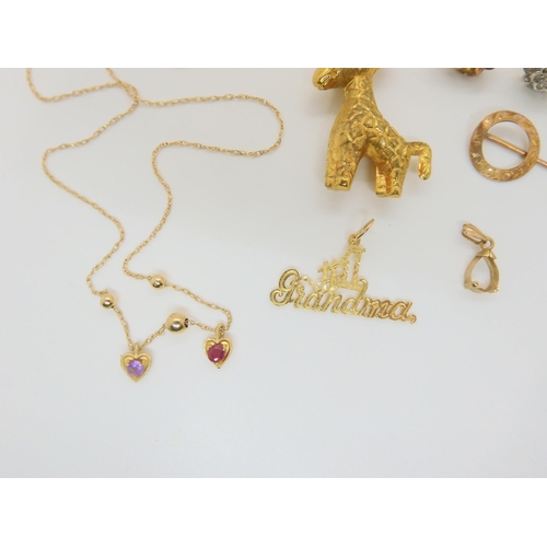 686 - A 14k gold 'Grandma' pendant and chain, weight 2.3gms, 9ct giraffe pendant, and other items of 9ct a... 