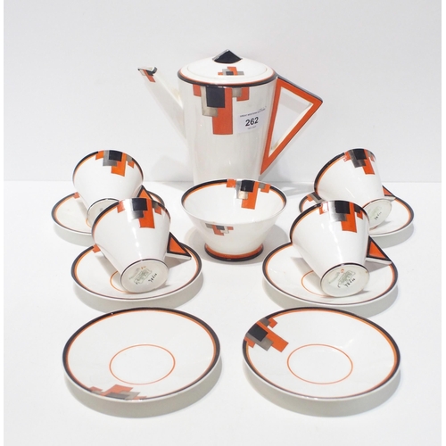 A Shelley Art Deco vogue shaped part coffee set comprising coffee pot, four cups, six saucers and a sugar bowl, in orange blocks, pattern number 11786 in orange, black and silver on white ground