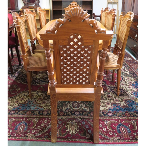 100 - A 20th century Indonesian hardwood dining table and eight chairs, dining table with shaped top on tw... 