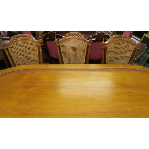 100 - A 20th century Indonesian hardwood dining table and eight chairs, dining table with shaped top on tw... 