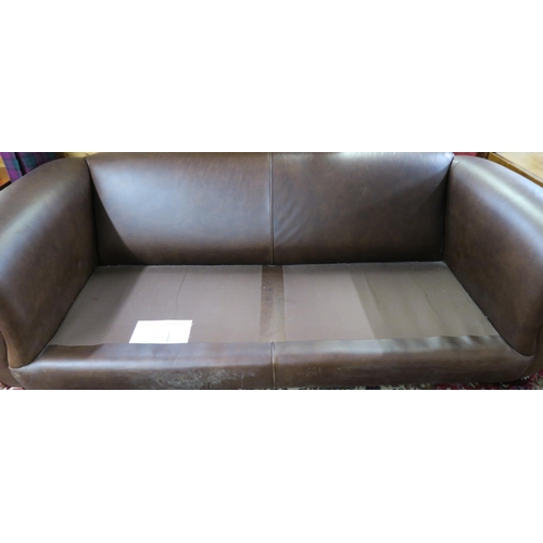 102 - A 20th century brown leather three seater settee red patterned cushions on shaped feet terminating i... 