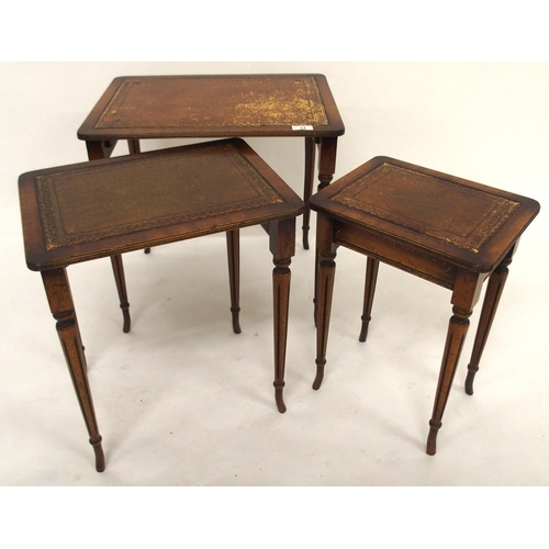 14 - A 20th century mahogany nest of three tables with leather skiver tops, a carved two tier occasional ... 