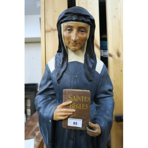 85 - A 20th century Parisian plaster statue of a nun, 82cm high and a brass of wood Crucifix on stepped b... 