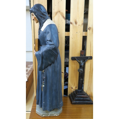 85 - A 20th century Parisian plaster statue of a nun, 82cm high and a brass of wood Crucifix on stepped b... 