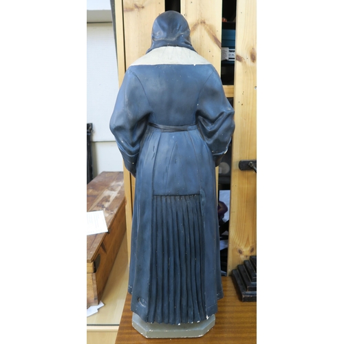 85 - A 20th century Parisian plaster statue of a nun, 82cm high and a brass of wood Crucifix on stepped b... 