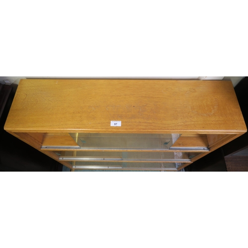 97 - A mid 20th century teak three tier sectional bookcase with glass sliding doors, 94cm high x 89cm wid... 