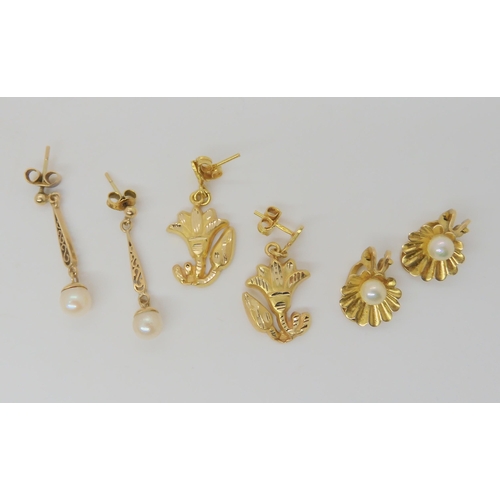 738A - A pair of Arabic gold flower earrings, weight 3.5gms together with tow pairs of 9ct gold pearl earri... 