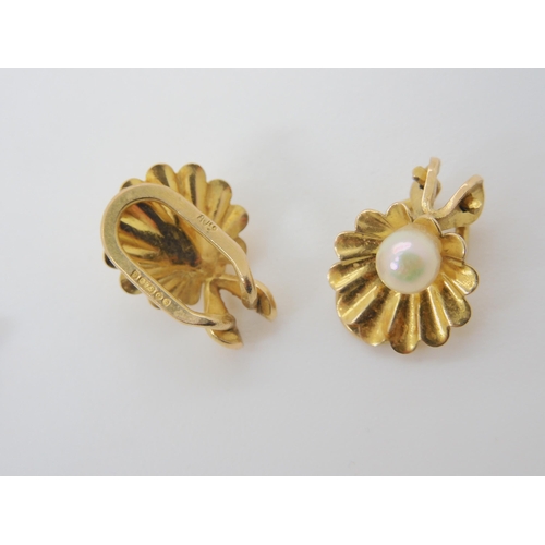 738A - A pair of Arabic gold flower earrings, weight 3.5gms together with tow pairs of 9ct gold pearl earri... 