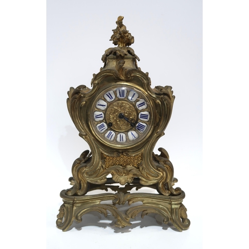 A French gilt metal clock of rococo style, the dial with white and blue enamel roman numeral plaques, the movement marked Carcel, Paris, 1040, 36cm high