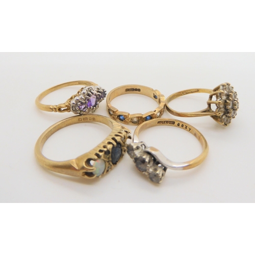 720 - Five 9ct gold gem set rings, to include an amethyst and diamond accent ring, size N, a clear gem clu... 