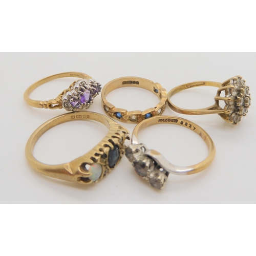 720 - Five 9ct gold gem set rings, to include an amethyst and diamond accent ring, size N, a clear gem clu... 