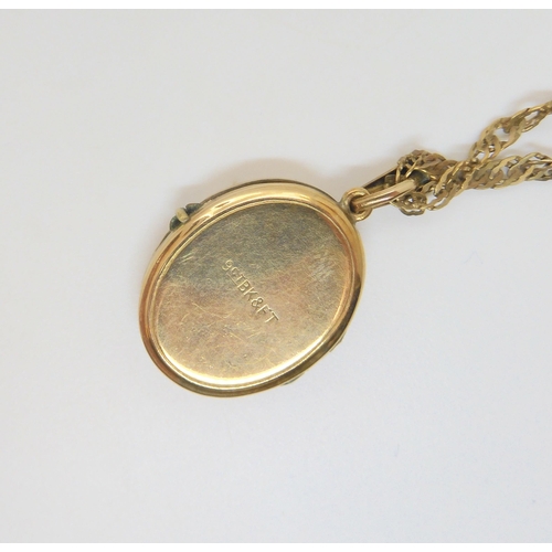 730 - A 9ct gold circular frame (?) a 9ct gold back & front locket with chain, weight together 9.2gms,... 