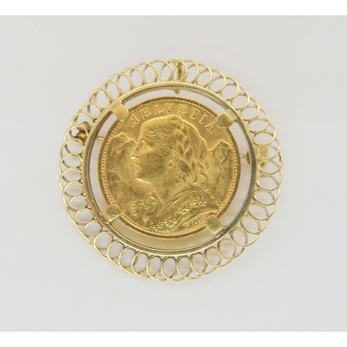 A 1935 Swiss Helvetia 20 Franc coin in a yellow metal brooch mount, weight all together 10.5gms