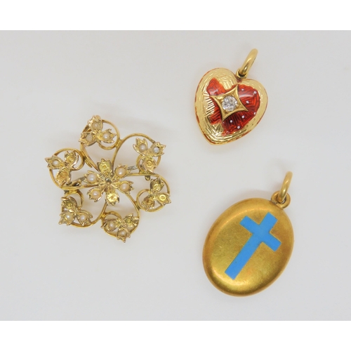 753 - A bright yellow metal locket with an enamelled cross to the front, with hair art under glazed panel ... 