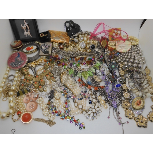 762 - A large box full of costume jewellery to include mirror compacts, statement necklaces etc