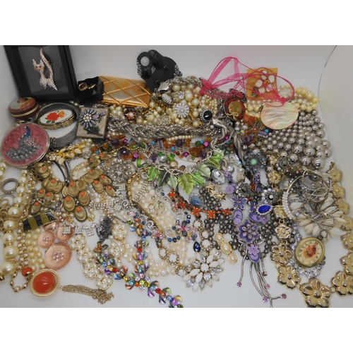 762 - A large box full of costume jewellery to include mirror compacts, statement necklaces etc