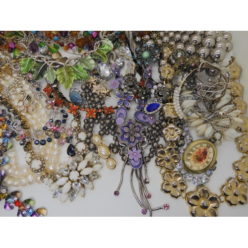 762 - A large box full of costume jewellery to include mirror compacts, statement necklaces etc