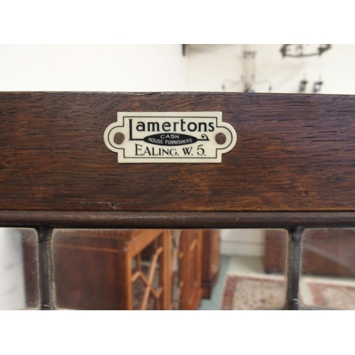 104 - A 20th century oak glazed bookcase with pair of leaded glass doors on cabriole supports, 128cm high ... 