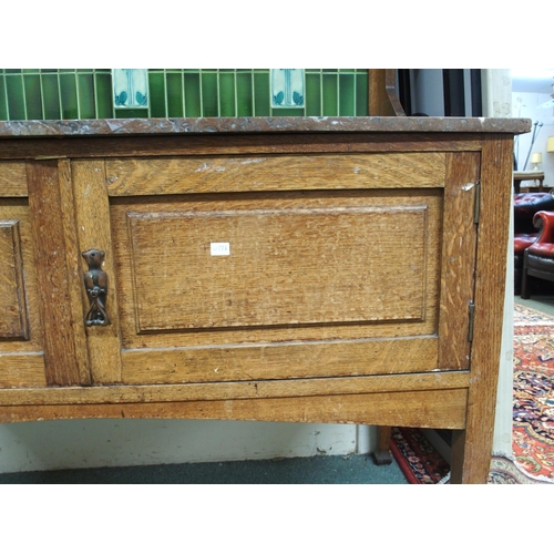 114 - A late Victorian oak arts and crafts washstand with green tiled splashback over marble top above pai... 