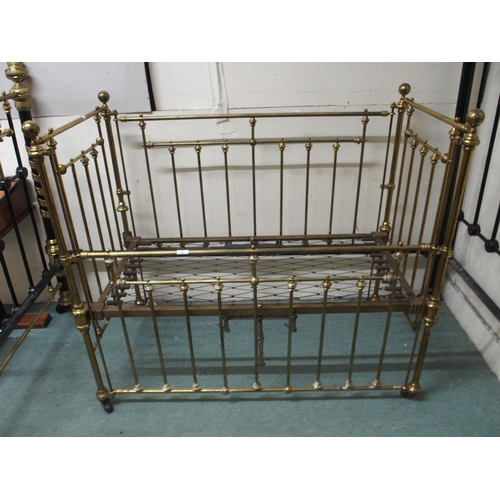 122 - A Victorian brass framed children's crib with drop sides, 117cm high x 68cm wide x 133cm long