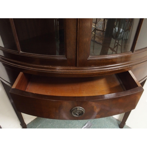 126 - A 20th century mahogany bow front glazed corner cabinet with pair of glazed doors over single drawer... 