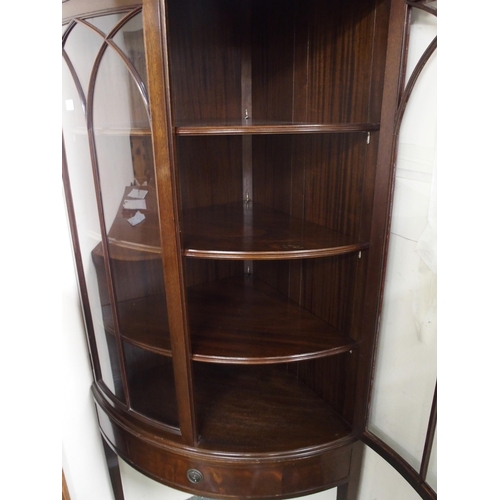 126 - A 20th century mahogany bow front glazed corner cabinet with pair of glazed doors over single drawer... 