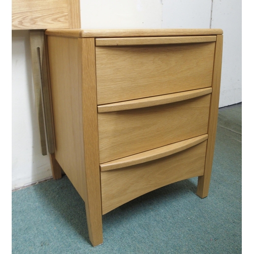 138 - A pair of contemporary beech Ercol three drawer bedside chests and a bergere headboard (3)