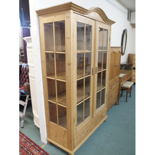 143 - A 20th century pine two door glazed display cabinet, 199cm high x 127cm wide x 56cm deep